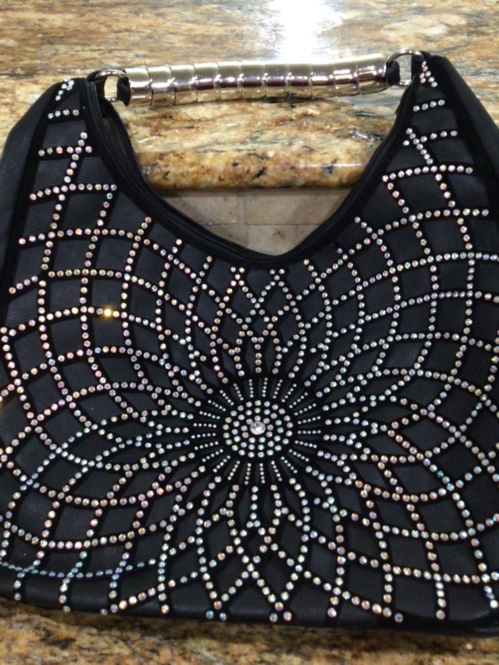 Unique unbranded purse with rhinestones. With  an unique handle  great shape